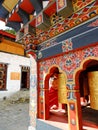 Monk peeping from the prayer wheel at Lhakhang Karpo, Paro, Bhutan Royalty Free Stock Photo