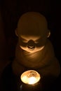 A monk pray for blessing with a candle