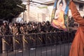 A monk raises a picture of Buddha to convince Riot army