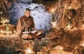 Monk reading book inside cave Royalty Free Stock Photo