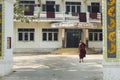 Burmese monk walking out his monastery Amarapura, Burma