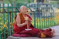 A Monk spins a karma wheel Royalty Free Stock Photo