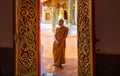 Monk standing inside Phra That Choeng Chum Temple Sakon Nakhon, Thailand