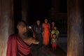 Monk taking photo of family in Myanmar