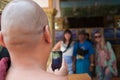 Monk taking photo of tourist