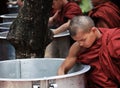 Monk taking rice from a big pan, myanmar