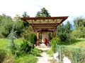 Monk turning prayer wheel at Simtokha Dzong in Bhutan
