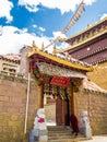 A monk walking into the door at Song Zan Lin in Shangri-la, Yunnan province in China Royalty Free Stock Photo