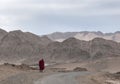 Monk walking with mountain backdrop, Ladakh, India