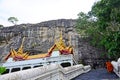 Monk walking on naga staircase go to praying Buddha at Wat Phra