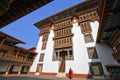 Monk walking in Paro Rinpung Dzong, Buddhist monastery and fortress on a hill near the Paro Chu river. Bhutanese style building d Royalty Free Stock Photo