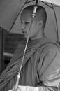 A monk walking with sun umbrella in Siem Reap,