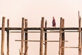 Monk walking on U-Bein bridge, in Amarapura, Mandalay, Burma Myanmar