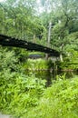 Monkey bridge for pedestrians and bikers next to the river Royalty Free Stock Photo