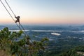 Monkey climbing on a rope at sunset time. Green jungle, fields and rivers. Karstic mountains and mist at the horizon. Kyar Inn