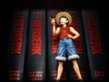 Monkey D Luffy Anime character toy on a book shelf Royalty Free Stock Photo