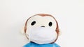 Monkey doll wearing a face mask.