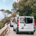 Monkey hanging on a taxi window by a circular road in Gibraltar Nature Reserve