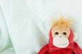 Monkey lying down relaxing on the bed Royalty Free Stock Photo