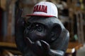 Monkey statue wearing a Canada baseball hat and sunglasses