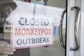 Monkeypox outbreak concept. text message paper Attached behind glass by people to closed service during the monkeypox virus