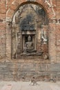 Monkeys in a brick temple archway in Lopburi Royalty Free Stock Photo