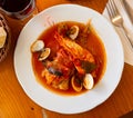 Monkfish tail in spicy sauce with shrimp and mussels