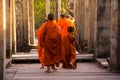 The monks in the ancient stone faces of Bayon temple, Angkor