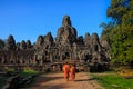 The monks in the ancient stone faces of Bayon temple, Cambodia