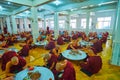 Monks in dining hall of Kha Khat Waing Kyaung Monastery, Bago, Myanmar