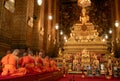 Monks meditating and praying in buddhist temple Bangkok
