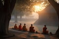 monks meditating in quiet courtyard, with view of the sunrise