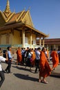 Monks and other young visitors explore National Palace