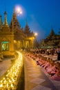 Monks praying in front of candles