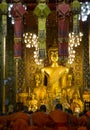 Monks praying in main hall at Lamphun temple