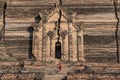 Monks with red traditional costumes and red umbrella in buddhist temple