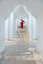 Monks with red traditional costumes and red umbrella in buddhist temple Royalty Free Stock Photo