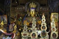 Monks stand before a Golden Buddha statue in Pelkor Chode Monastery in Tibet