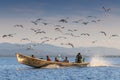 Monks and tourists take a boat trip to Inle lake to visit villages, temples, and floating farm. Taking a boat is a common way to