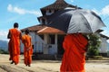 Monks with umbrella