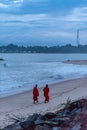 Monks walk the beach in Sunset in the beach of Tangalle, Sri Lanka