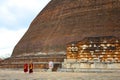 Monks Walk Past Huge Jetavanarama Stupa in Sri Lanka