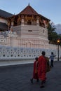 Monks walk past the Temple of the Sacred Tooth Relic in Kandy, Sri Lanka.