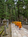 Monks walking on the 2 km long path with ancient tombs in the Okunoin cemetery towards the mausoleum of Kobo Daishi in the Unesco