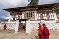 Monks walking past building in Rinpung dzong