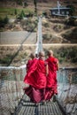 Monks or well know as Lama in Tibet walking on the bridge ,Bhutan