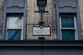 Monmouth Street name sign on a brick wall building in Covent Garden, London, UK.