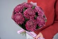Mono bouquet of chrysanthemum in womans hands. European floral shop. the work of the florist at a flower shop. Delivery