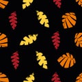 Mono print style scattered leaves seamless vector pattern background. Textured cut out yellow, red, orange on black