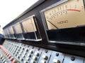 Mono VU meter in sharp focus,on a  analogue ,multi channel ,studio mixing console Royalty Free Stock Photo